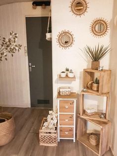 a room that has some shelves and baskets on the floor in front of an open door