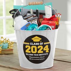 a bucket filled with school supplies on top of a wooden table