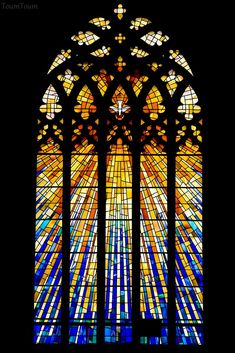 a very large stained glass window with many colors on it's windowsills