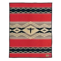 a red, black and white blanket with a cross on it's center piece