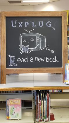 a blackboard with the words unplug read a new book on it