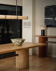 a bowl sitting on top of a wooden table