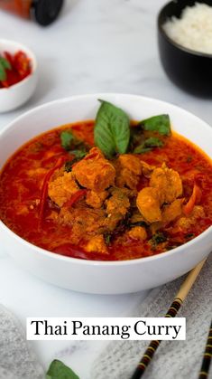 thai chicken curry in a white bowl with chopsticks on the side next to it