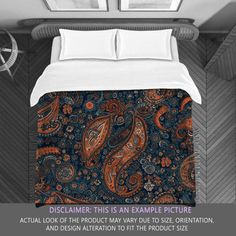 a bed with an orange and blue paisley pattern on it