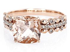 an engagement ring with a large pink diamond surrounded by small white and rose gold diamonds