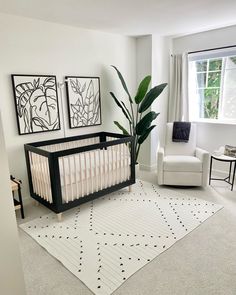 a baby crib in a white and black nursery