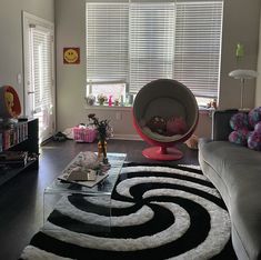 a living room filled with furniture and a large rug on top of a hard wood floor