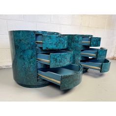 a set of four blue marbled metal drawers