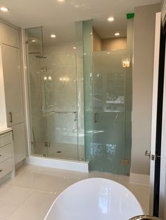 a bathroom with a tub, sink and shower stall in it's own area