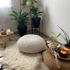 a living room with plants and rugs on the floor