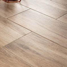 a wooden floor that has been cleaned and is laying on top of the floor next to a chair