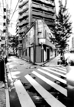 a black and white photo of a building in the middle of a street with trees on both sides