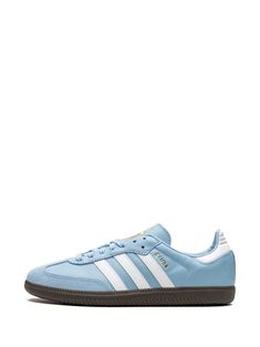 Find ADIDAS Samba Team Argentina Sneakers on Editorialist. light blue/white signature 3-Stripes logo logo print to the side round toe front lace-up fastening logo-print tongue contrasting heel counter gum-rubber sole These styles are supplied by a premium sneaker marketplace. Stocking only the most sought-after footwear, they source and curate some of the most hard to find sneakers from around the world. Light Blue Adidas Shoes, Sporty Light Blue Sneakers With Contrast Sole, Light Blue Lace-up Sneakers With Rubber Sole, Sporty Custom Sneakers With Rubber Sole In Light Blue, Adidas Running Sneakers With Contrast Sole, Adidas Sneakers With Contrast Sole For Running, Blue Low-top Sneakers With Three Stripes, Light Blue High-top Sneakers With Gum Sole, Light Blue Lace-up Sneakers With Vulcanized Sole