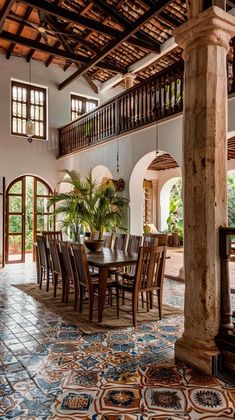 a dining room table and chairs in front of an open floor plan