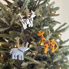 the christmas tree is decorated with animals and lights, including zebras or giraffes