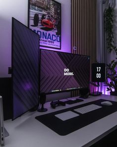 two computer monitors sitting on top of a desk next to a keyboard and monitor screen