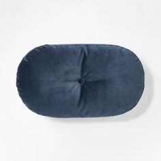 a blue round pillow on a white background