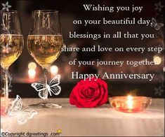 two glasses of wine and a rose on a table with the words wishing you joy on your beautiful day blessings in all that you share and love on every step of your journey together