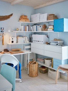 a room filled with lots of white furniture and bookshelves on top of shelves