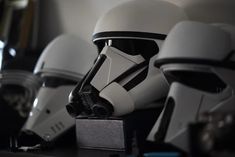 star wars helmets are lined up on a shelf