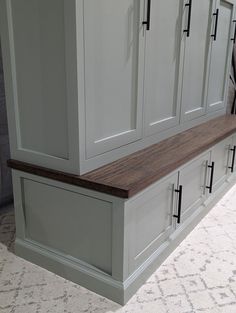 an image of a kitchen setting with cupboards on the wall and carpeted floor