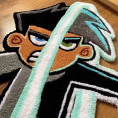 a rug with an image of a cartoon character on it, sitting on a wooden floor