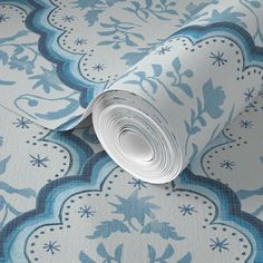 a blue and white wallpaper with an ornate design on it's surface,