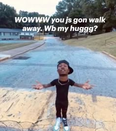 a young boy standing on the side of a road with his arms outstretched in front of him