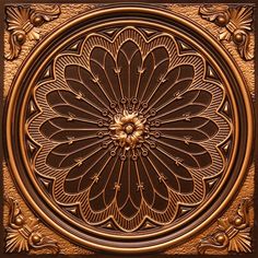 an intricately designed metal plate with flowers and leaves in the center, on a brown background