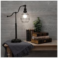 a lamp on a table next to some books