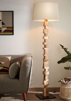 a living room with a couch, lamp and pictures on the wall