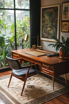 a wooden desk sitting in front of a window next to a chair and potted plant