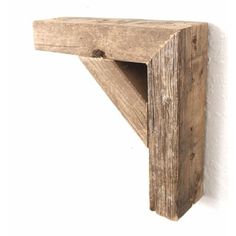 a wooden shelf on the wall is made out of wood and has two holes in it