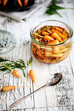 carrots are in a glass jar on a table