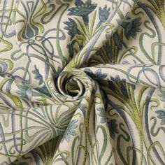 an up close shot of a fabric with blue, green and white designs on it