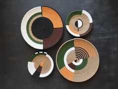 four plates with different designs on them sitting next to each other in the shape of circles