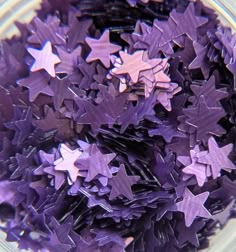 many purple stars are in a glass bowl