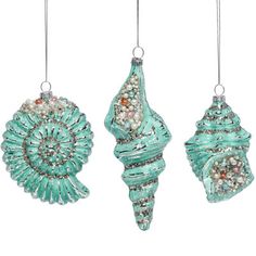 three christmas ornaments hanging from strings on a white background, each decorated with beads and pearls