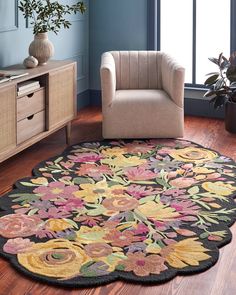 a living room with a chair and rug on the floor