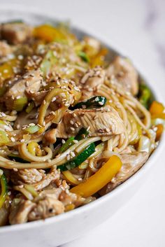 a white bowl filled with noodles and vegetables