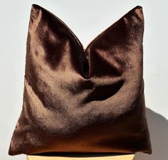 a brown pillow sitting on top of a wooden table