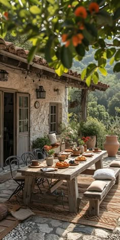 an outdoor dining area with table and chairs