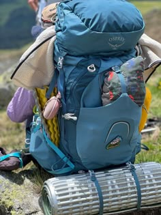 a blue backpack sitting on top of a rock