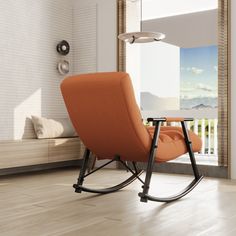 an orange rocking chair sitting in front of a window