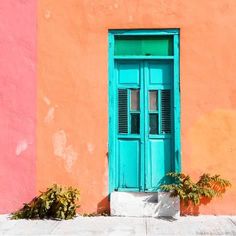 a blue door and window on an orange building