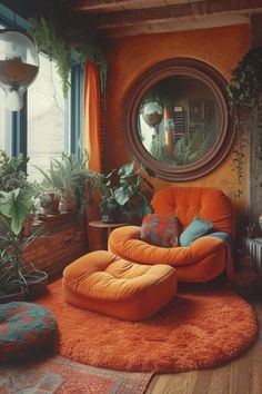 an orange chair and ottoman in front of a round mirror with potted plants on it