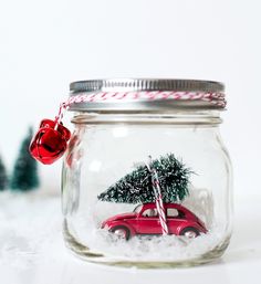 a red car with a christmas tree on top in a jar