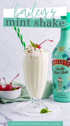 a bottle of bailey's mint shake next to a glass filled with whipped cream