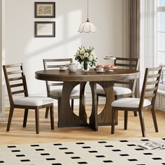 a dining table with four chairs and a vase on the table in front of it