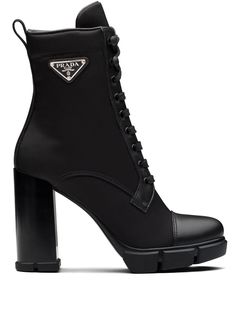 Black leather triangle-logo 110mm boots from PRADA featuring enamel triangle logo, round toe, pull-tab at the heel, faux lace-up design, side zip fastening and 110mm block heel. | Prada Triangle-Logo 110mm Boots Parent Dr, Celebrity Clothing, Heels Winter, Prada Boots, Prada Heels, Hak Tinggi, Pretty Heels, Dr Closet, Designer Woman